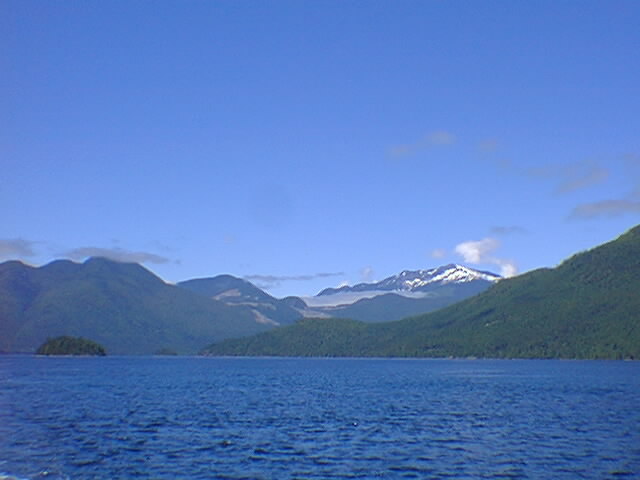 Blue sea, blue sky, blue mountains.  Monochromatic picture